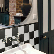 White and black checkerboard sticke wall tile by Smart Tiles in a rustic bathroom with exposed brick