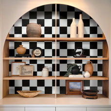 White and black checkerboard self-adhesive backsplash tile by Smart Tiles inside a cabinet with vintage accessories.